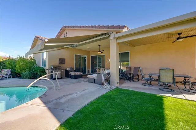 a view of a house with patio and a yard