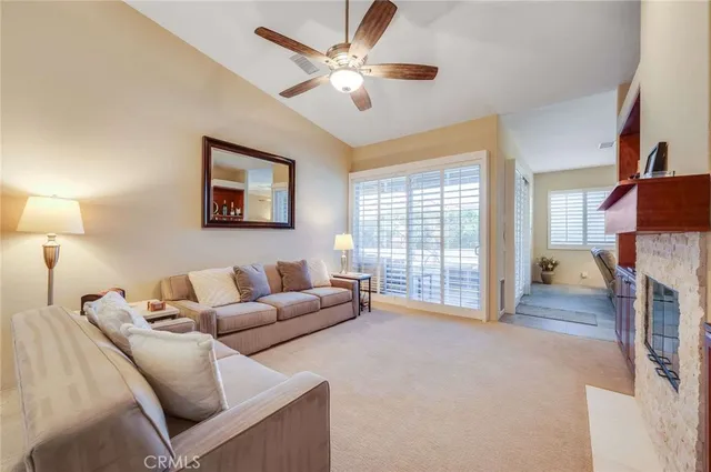 a living room with furniture and a fireplace