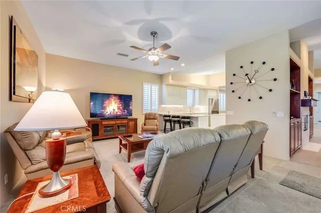 a living room with furniture a large window and a flat screen tv