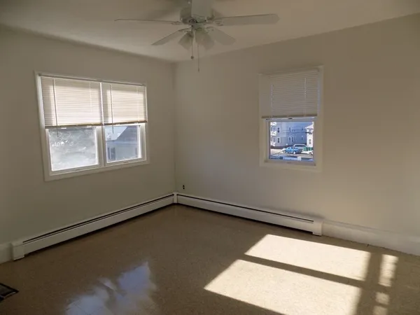 a view of a room with wooden floor and windows