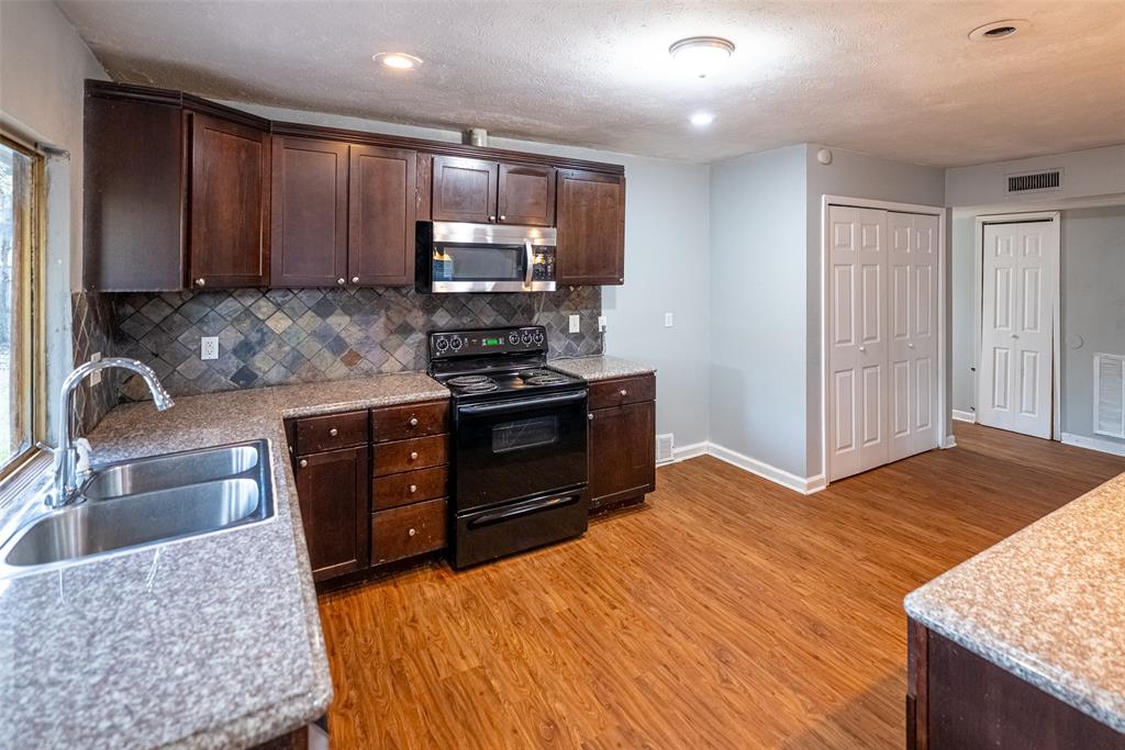 3401 Tarkio Road Plano, TX 75074 - Photo 5 of 11 a kitchen with stainless steel appliances granite countertop a sink stove and refrigerator