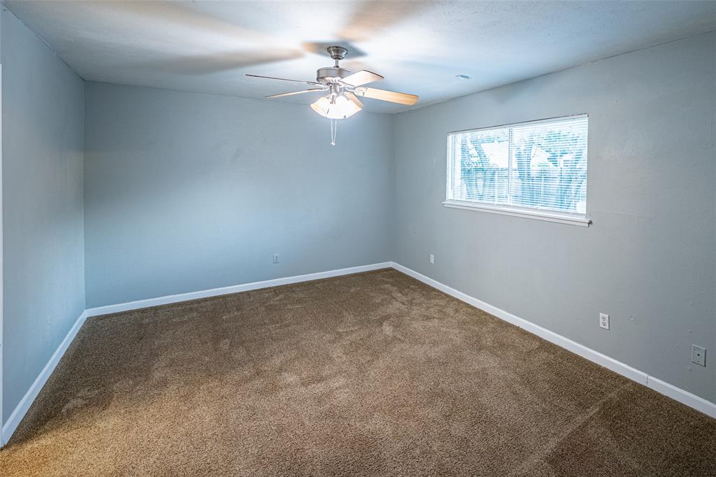 3401 Tarkio Road Plano, TX 75074 - Photo 9 of 11 an empty room with windows and chandelier fan
