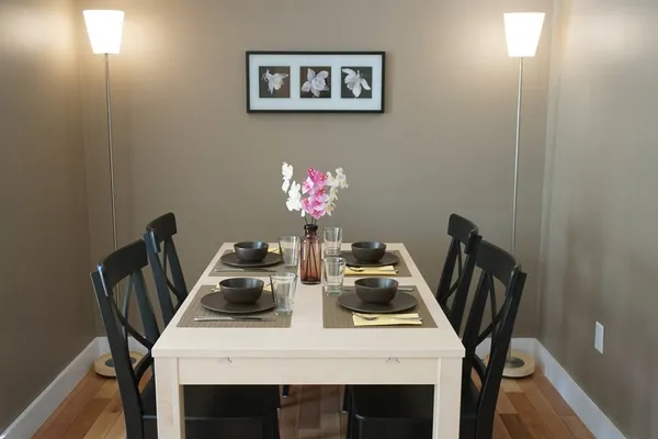 a view of a dining room with furniture and chandelier