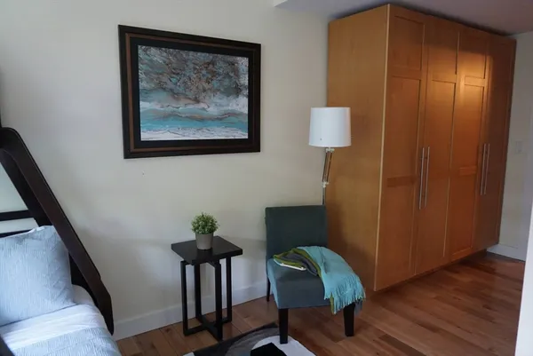 a view of a workspace room with wooden floor and cabinet