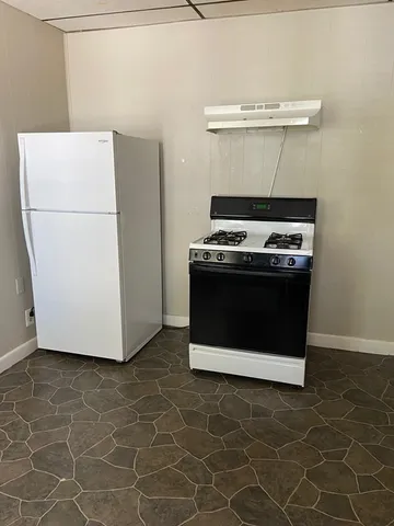 a stove top oven sitting inside of a kitchen