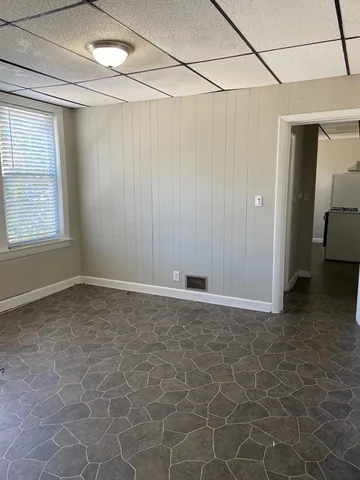 a view of a room with a empty space and windows