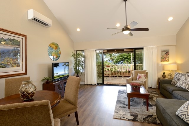 2777 South Kihei Road, Unit A207 Kihei, HI 96753 - Photo 2 of 30 a living room with furniture a fireplace and a large window