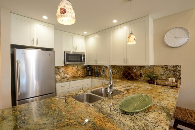 2777 South Kihei Road, Unit A207 Kihei, HI 96753 - Photo 4 of 30 a kitchen with granite countertop a sink a stove and a refrigerator