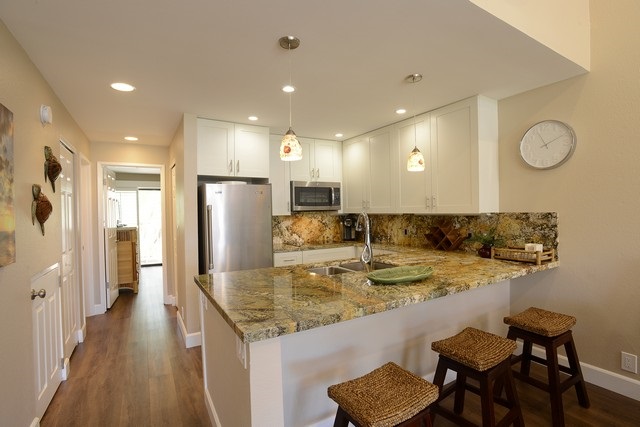 2777 South Kihei Road, Unit A207 Kihei, HI 96753 - Photo 10 of 30 a kitchen with kitchen island granite countertop a sink and refrigerator
