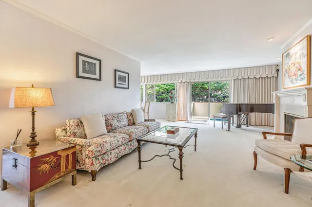 a dining room with furniture a chandelier and a rug