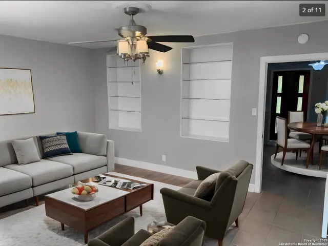 a living room with furniture a rug and a window