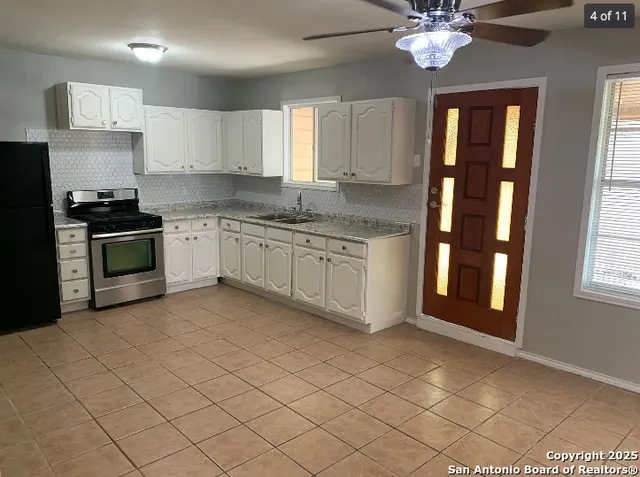 a kitchen with stainless steel appliances granite countertop a stove sink and cabinets