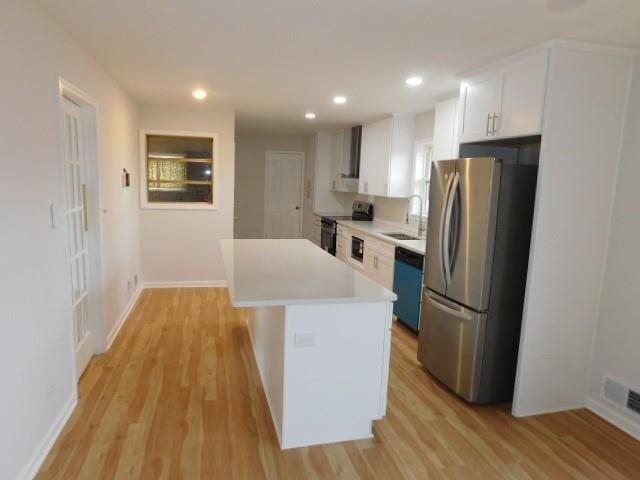 2407 Summerland Drive Decatur, GA 30032 - Photo 10 of 22 a kitchen with stainless steel appliances a refrigerator and wooden floor