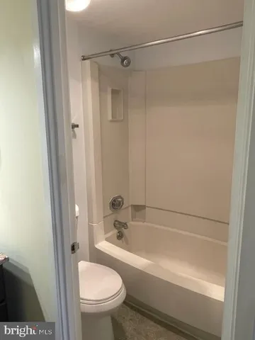 a view of a room with wooden floor and a cabinet