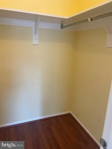 a view of a room with wooden floor and entrance