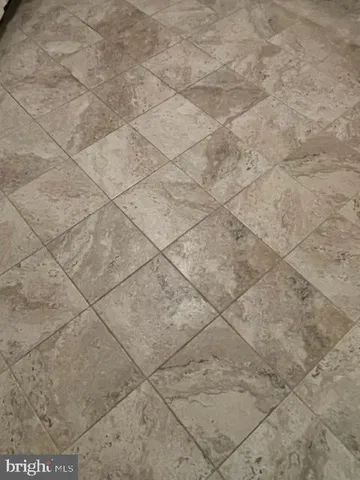 a dirty bathroom with white tiles