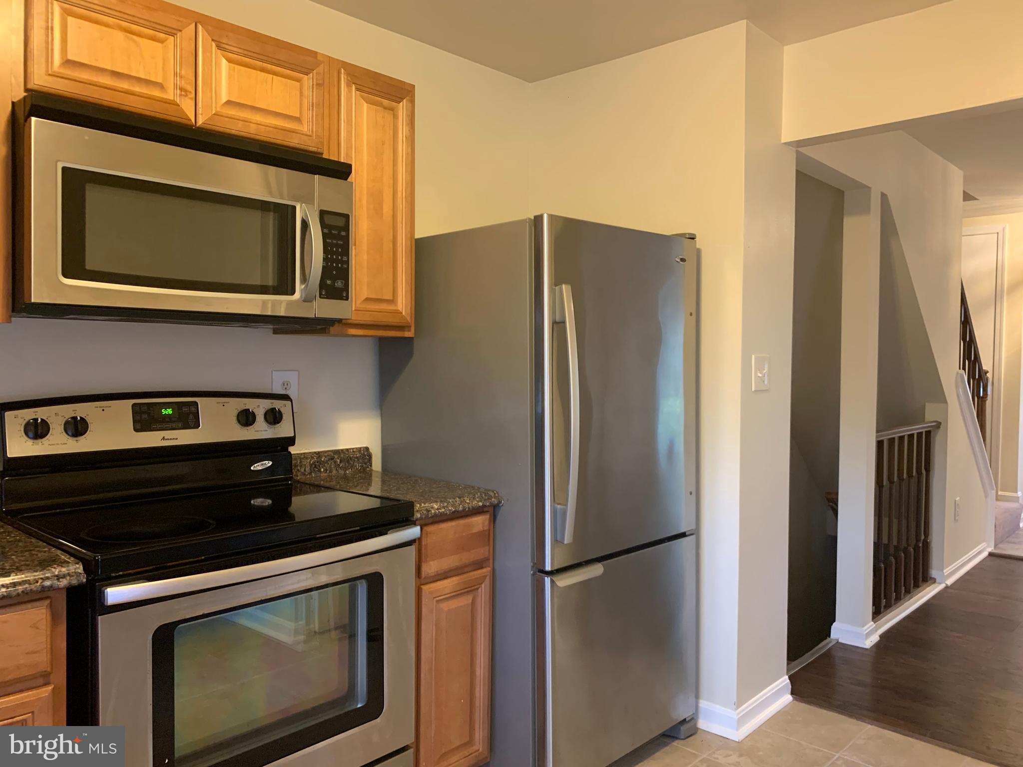 1658 Colonial Way Frederick, MD 21702 - Photo 2 of 32 a kitchen with stainless steel appliances a stove a microwave and a refrigerator