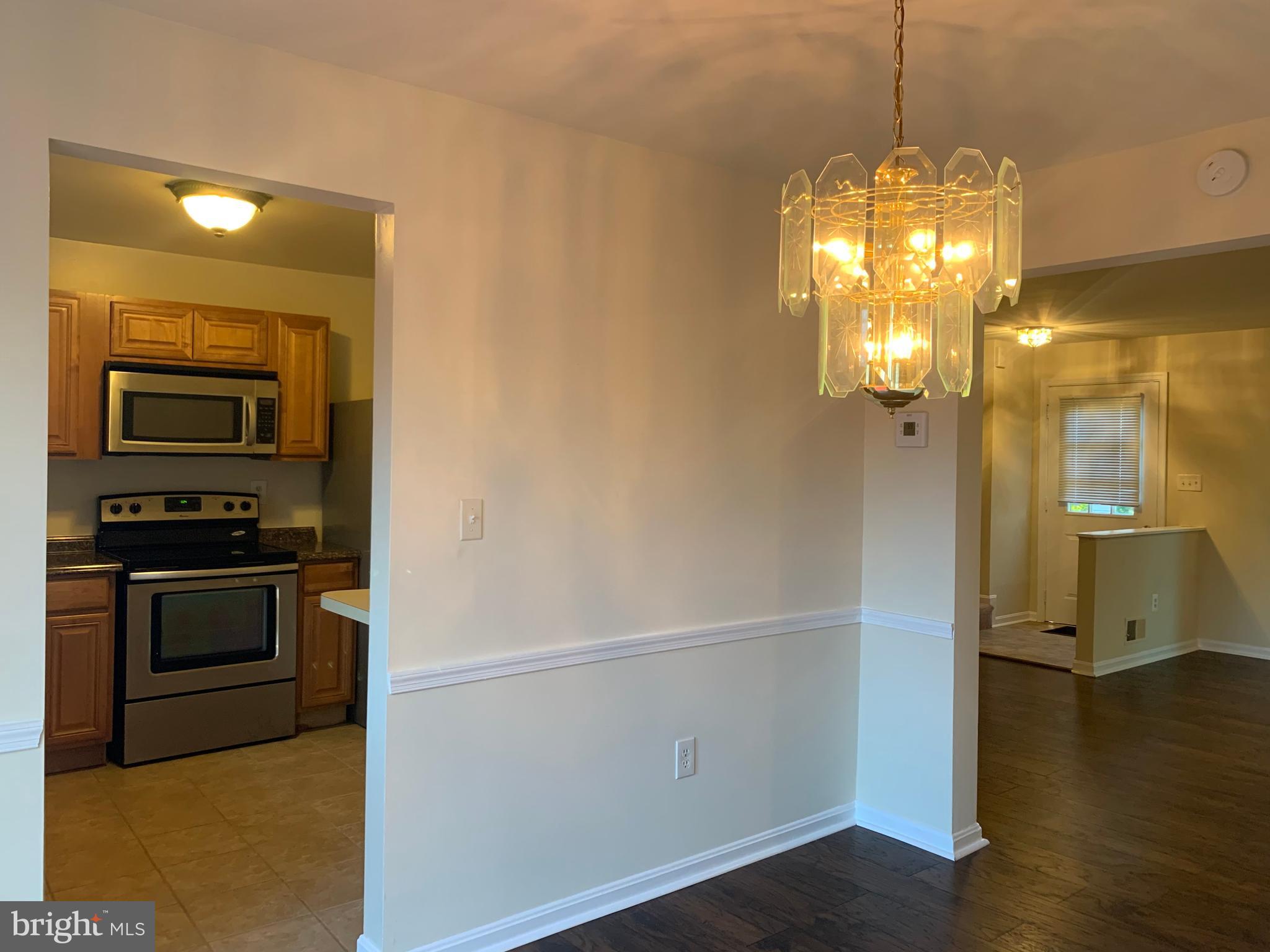 1658 Colonial Way Frederick, MD 21702 - Photo 6 of 32 a view of a kitchen with a sink wooden floor and a living room