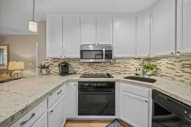 a kitchen with granite countertop cabinets stainless steel appliances and sink