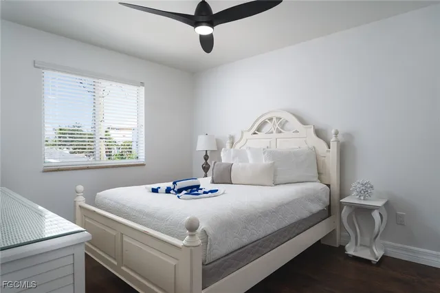 a bedroom with a bed and a potted plant
