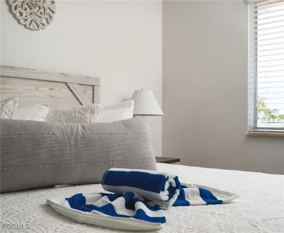 a living room with furniture and a lamp