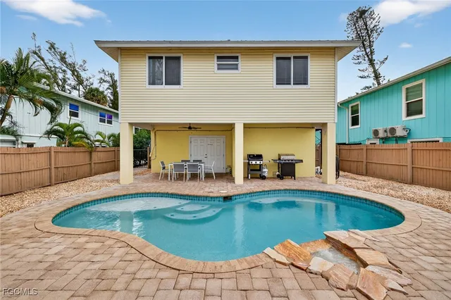 a view of a swimming pool with potted plants