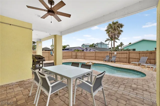 a view of a dining room with furniture and a chandelier