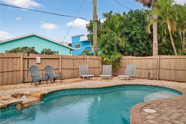 a view of a backyard with a patio and outdoor seating