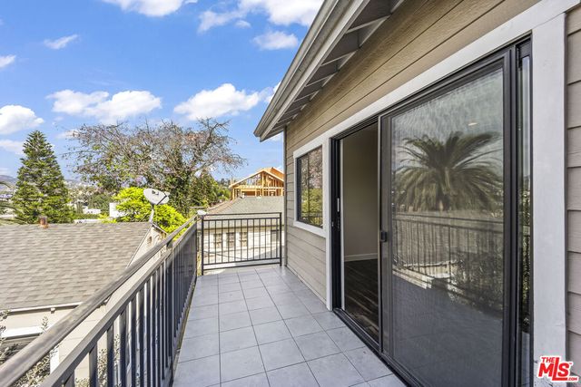 a view of balcony with wooden floor