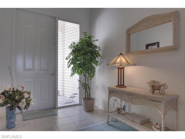 400 Harvard Court Naples, FL 34104 - Photo 11 of 16 a potted plant sitting on top of a wooden floor