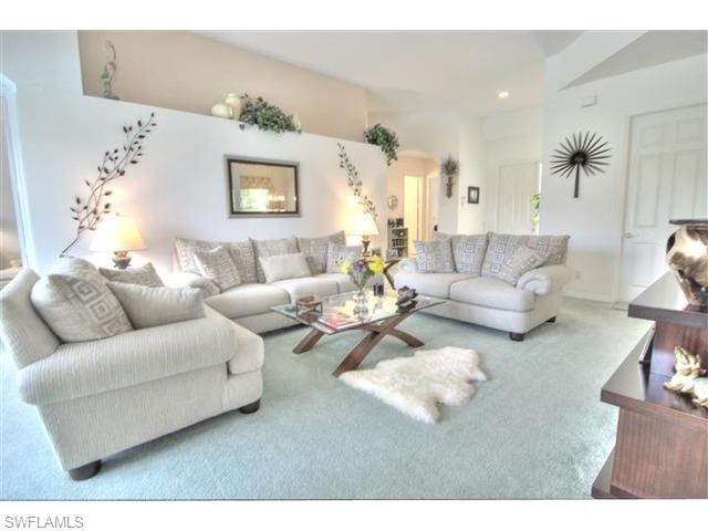 400 Harvard Court Naples, FL 34104 - Photo 5 of 16 a living room with furniture and a table