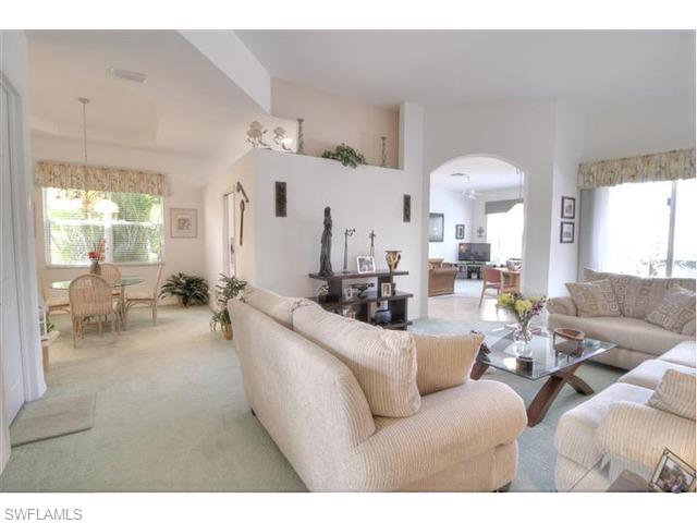 400 Harvard Court Naples, FL 34104 - Photo 6 of 16 a living room with furniture and a large window