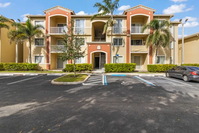 a front view of a residential apartment building with a yard