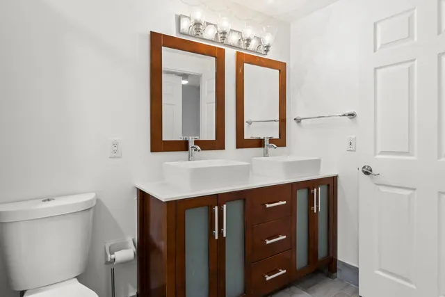 a bathroom with a sink a toilet and mirror