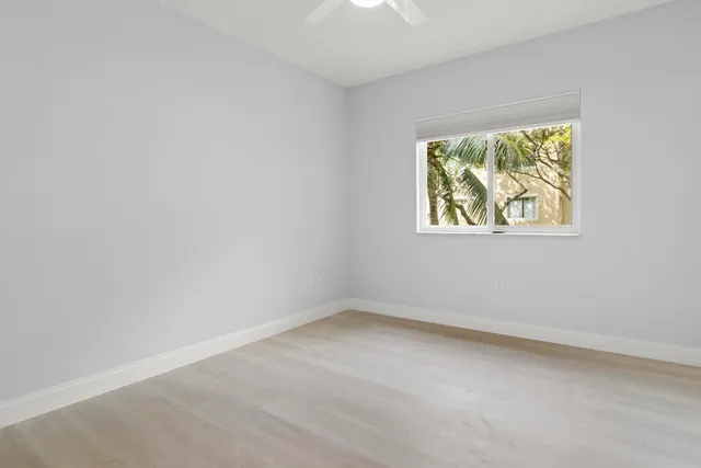 a view of a livingroom with wooden floor and staircase