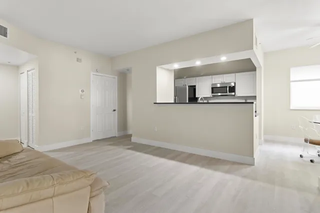 a spacious bedroom with a large bed and a large window