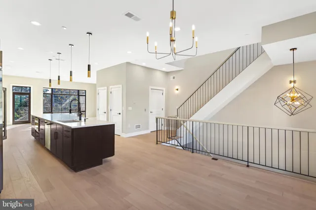 a view of kitchen and hall with wooden floor