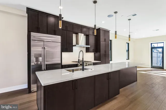 a kitchen with a sink a counter space and stainless steel appliances