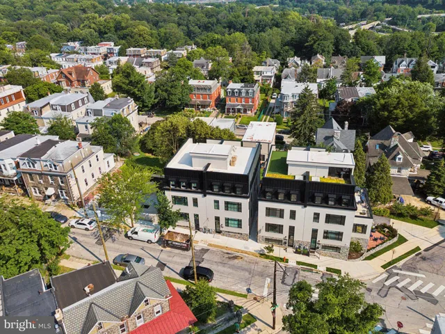 an aerial view of residential houses with yard