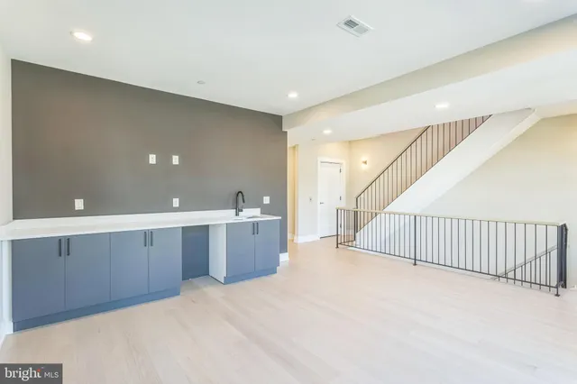a view of a kitchen with a sink staircase and a living room