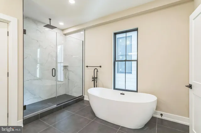 a bathroom with a bathtub and shower