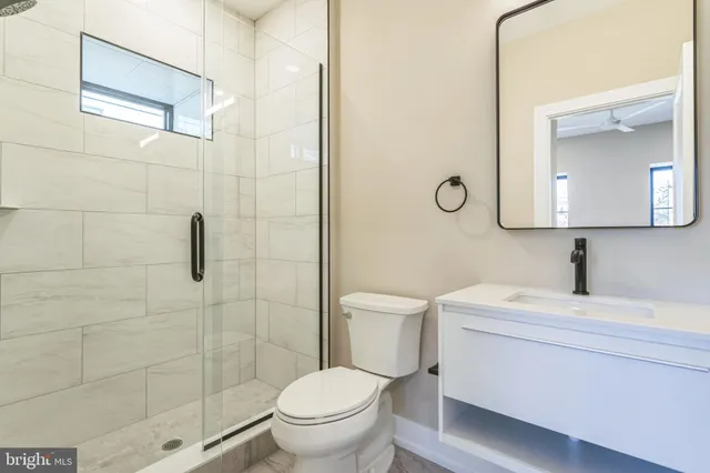 a bathroom with a toilet sink and shower
