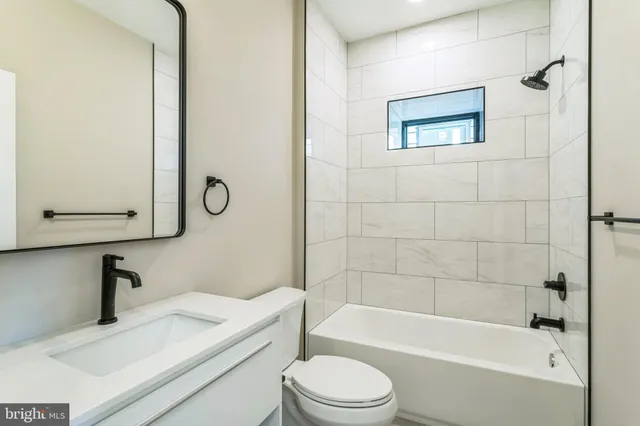 a bathroom with a sink a toilet and a bathtub
