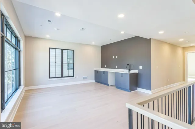 a view of a big room with windows and stairs