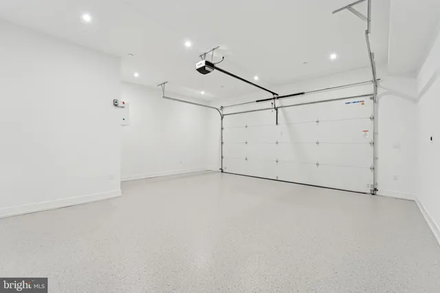 a view of two chairs and table in a back yard