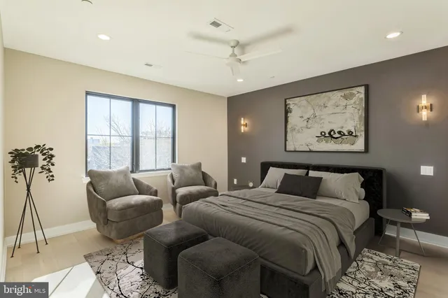 a bedroom with furniture and a large window