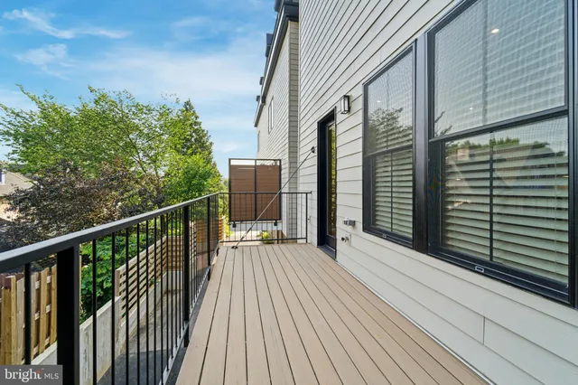 a view of a balcony with wooden floor and fence
