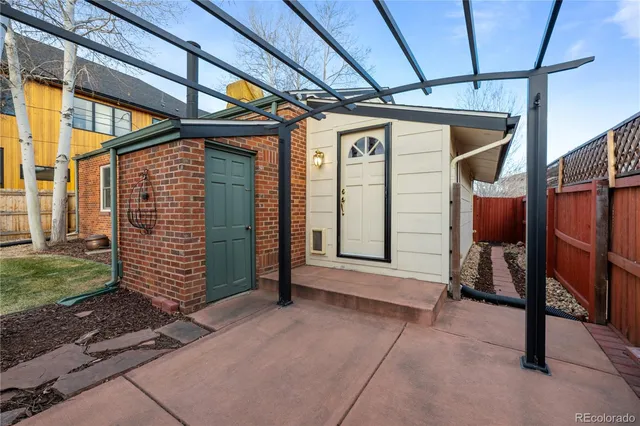 a view of house with backyard and glass windows