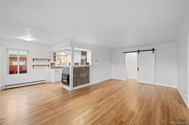 a big room with wooden floor and windows