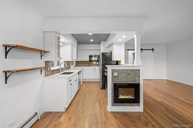 a large kitchen with cabinets a sink and a stove